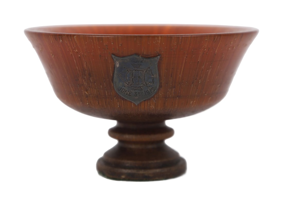 EARLY 20TH - CENTURY TURNED HORN TROPHY BOWL: Of flared circular form on a pedestal foot, applied with a silver shield plaque engraved “1915”. OBJETS D'ART