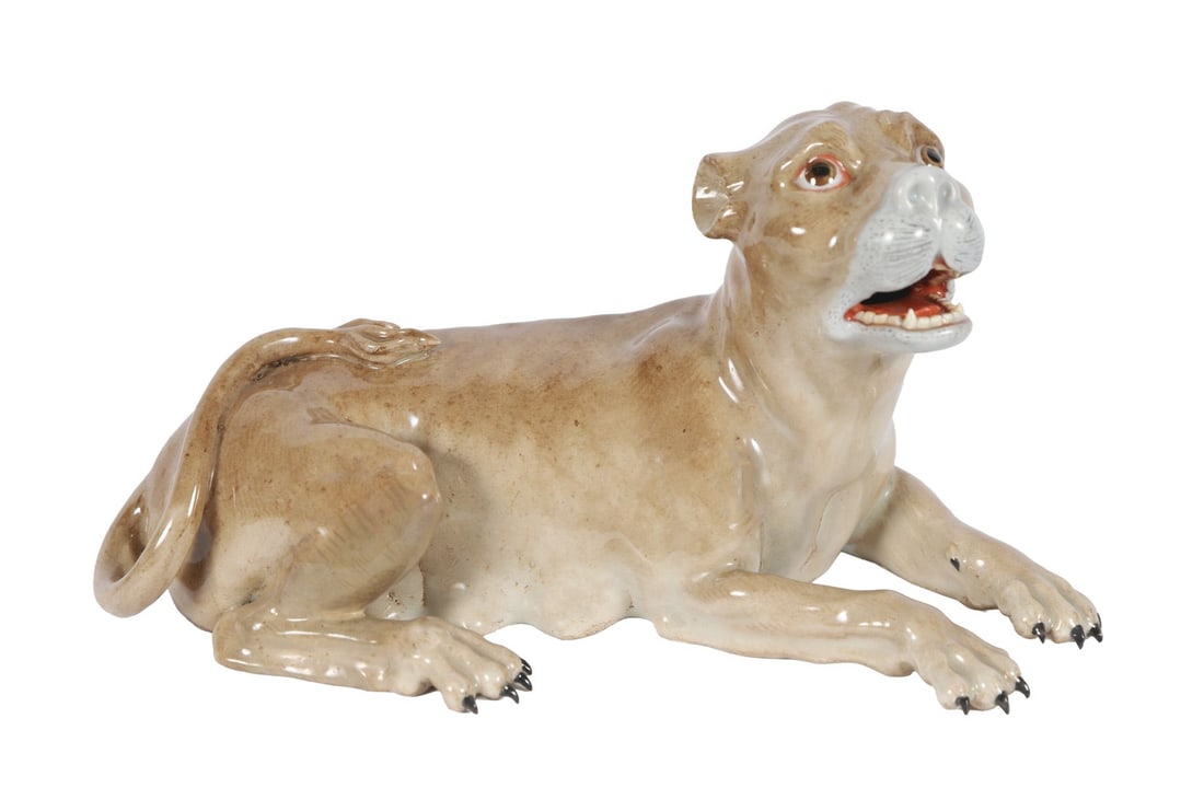 19TH-CENTURY MEISSEN PORCELAIN FIGURE: OF A RECUMBENT CANINE, Modelled as a reclining dog with alert expression, the surface with naturalistic glaze. PORCELAIN