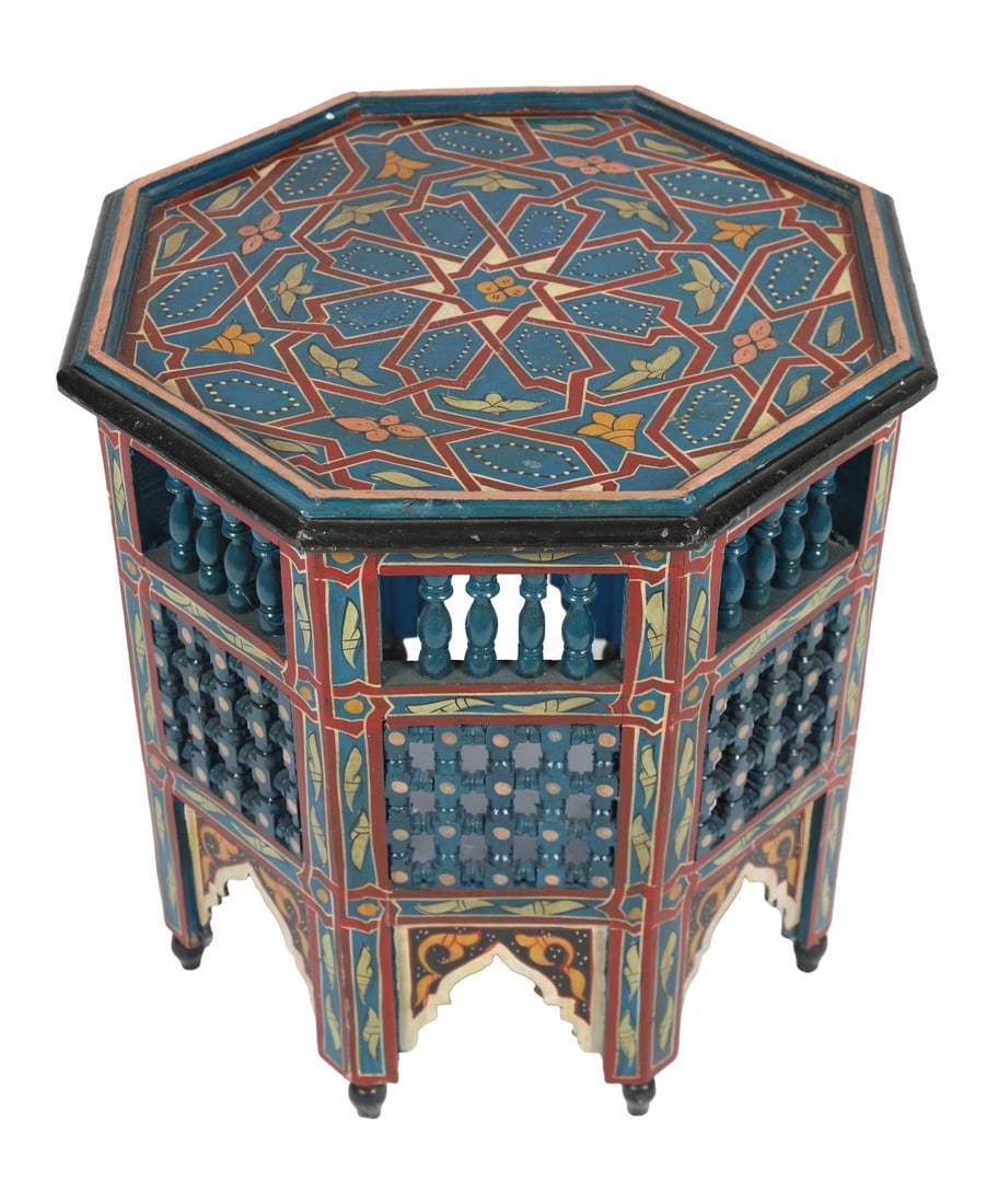 20TH - CENTURY MOROCCAN PAINTED OCCASIONAL TABLE: A 20th-century Moroccan octagonal occasional table, profusely decorated in polychrome with geometric and foliate motifs, the pierced sides with turned spindle galleries and Moorish arch panels. FURNIT