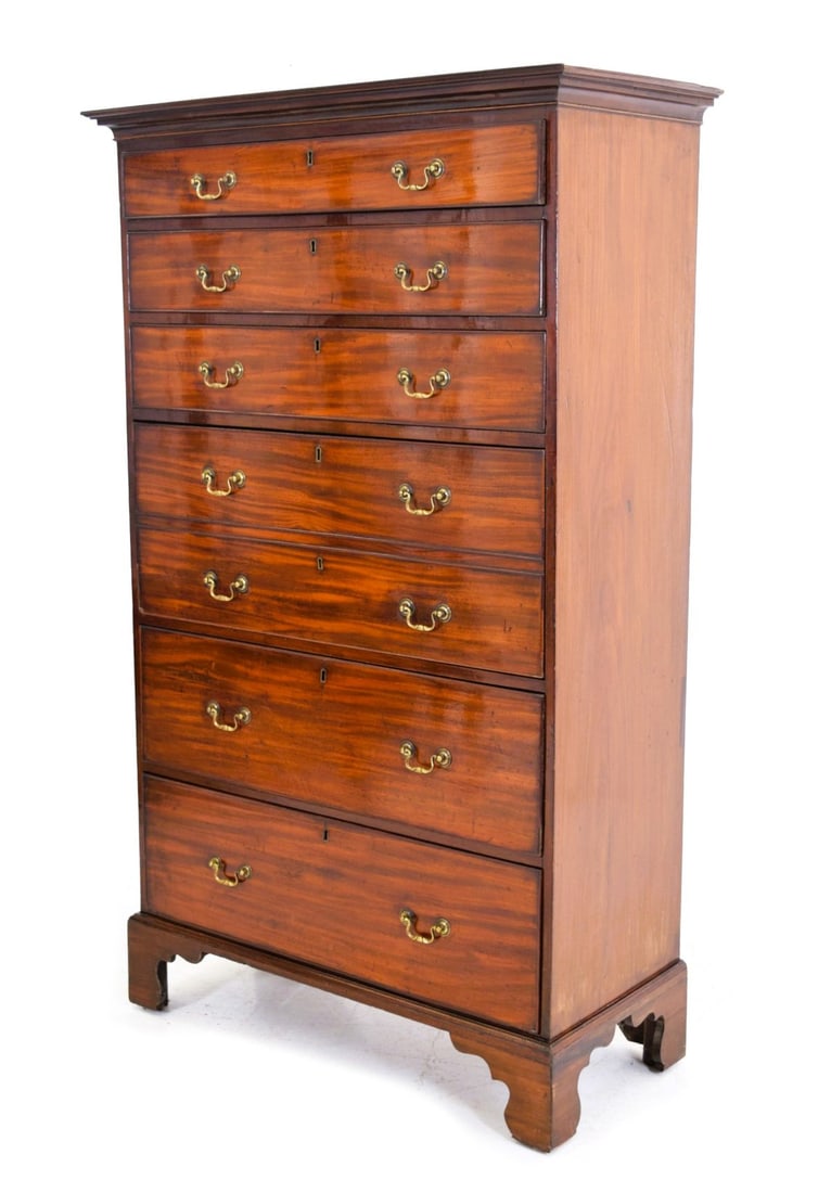 GEORGIAN MAHOGANY TALLBOY WITH SECRETAIRE DRAWER: The upper section with secretaire drawer above an arrangement of drawers, the lower section with further drawers, raised on bracket feet. FURNITURE
