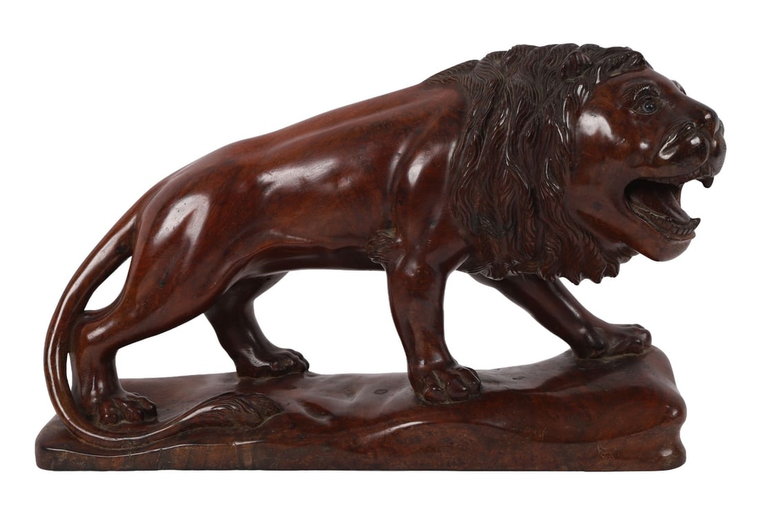 19TH-CENTURY CARVED HARDWOOD SCULPTURE OF A LION: Naturalistically modelled standing lion, carved in hardwood, mounted on an integral base. SCULPTURE