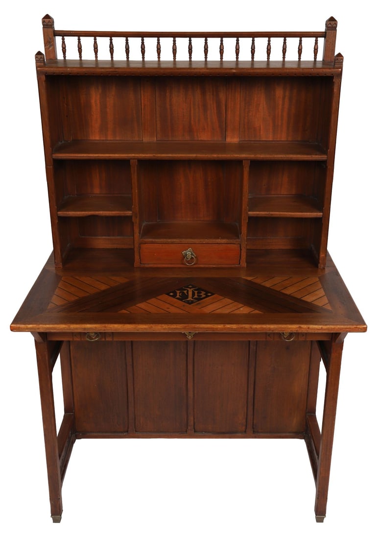ARTS AND CRAFTS WALNUT WRITING TABLE: An Arts and Crafts walnut writing table, the rectangular top with geometric inlay, above drawers and open compartments, the superstructure with gallery, raised on square tapering supports. FURNITURE