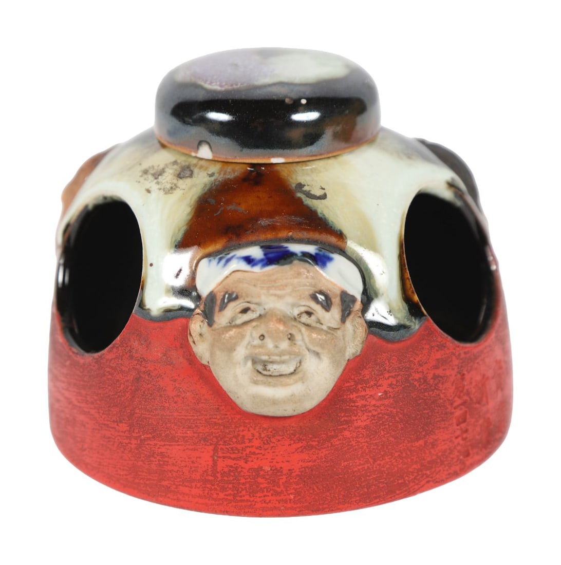 JAPANESE STUDIO POTTERY BRUSH POT: Of globular form with applied mask decoration and mottled glaze in red, black, and celadon tones. JAPANESE
