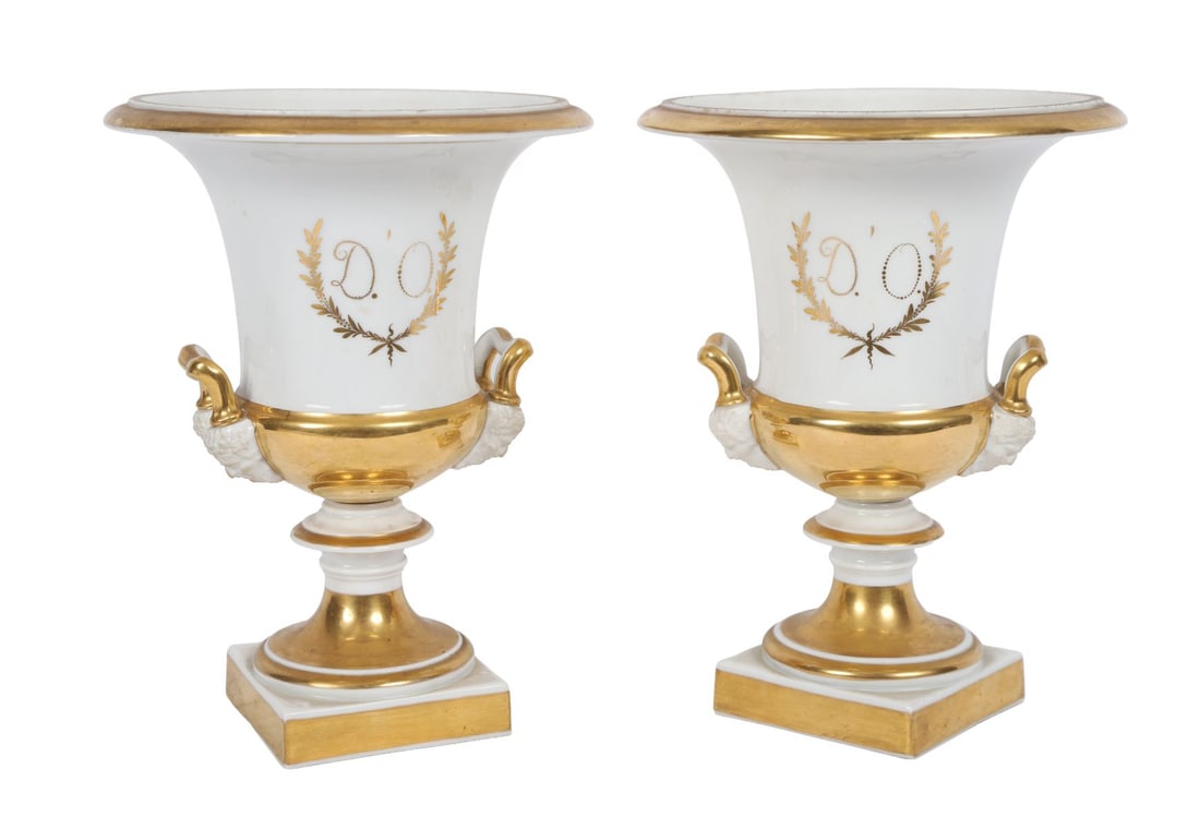 PR 19TH-CENTURY FRENCH PORCELAIN URNS: PARCEL-GILT, Each of campana form with twin handles, decorated with monogram ‘D.O.’ within laurel wreaths, raised on square bases. PORCELAIN