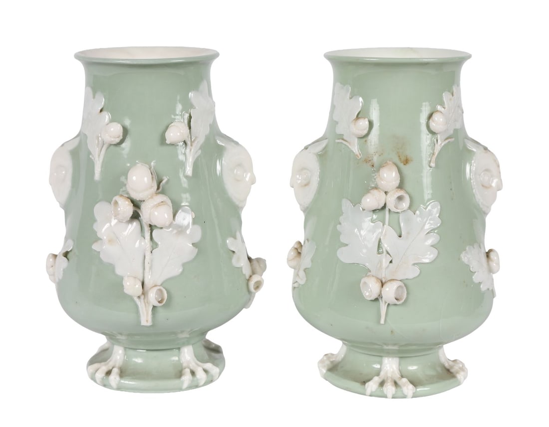 PAIR OF 19TH CENTURY MINTON OWL MOUNTED VASES: A pair of 19th-century Minton celadon-ground vases, each applied with relief foliage and modelled with perched owls to the sides, raised on circular bases. PORCELAIN