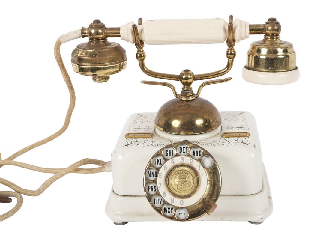 VINTAGE TELEPHONE: Early 20th-century telephone with ceramic body and brass fittings, fitted with rotary dial and twin receivers. OBJETS D'ART