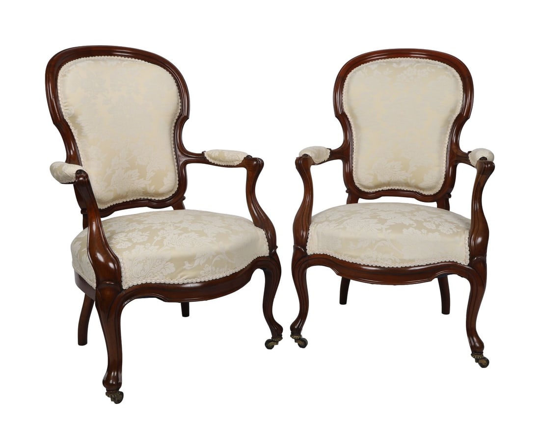 PR 19TH-CENTURY MAHOGANY UPHOLSTERED ARMCHAIRS: SHOW-FRAMED BALLOON-BACK, Each chair features a serpentine-fronted seat between scroll-fronted arms, raised on cabriole legs terminating on castors. FURNITURE