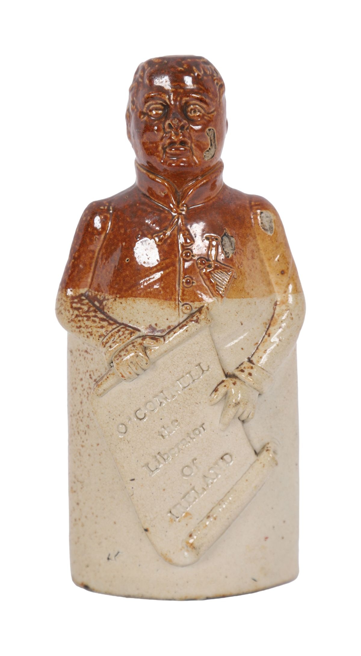 DOULTON LAMBETH STONEWARE FIGURAL FLASK: LATE 19TH-CENTURY , Stoneware flask modelled as a gentleman holding a scroll inscribed “O’Connell the Liberator of Ireland”, with impressed Doulton Lambeth marks. PORCELAIN