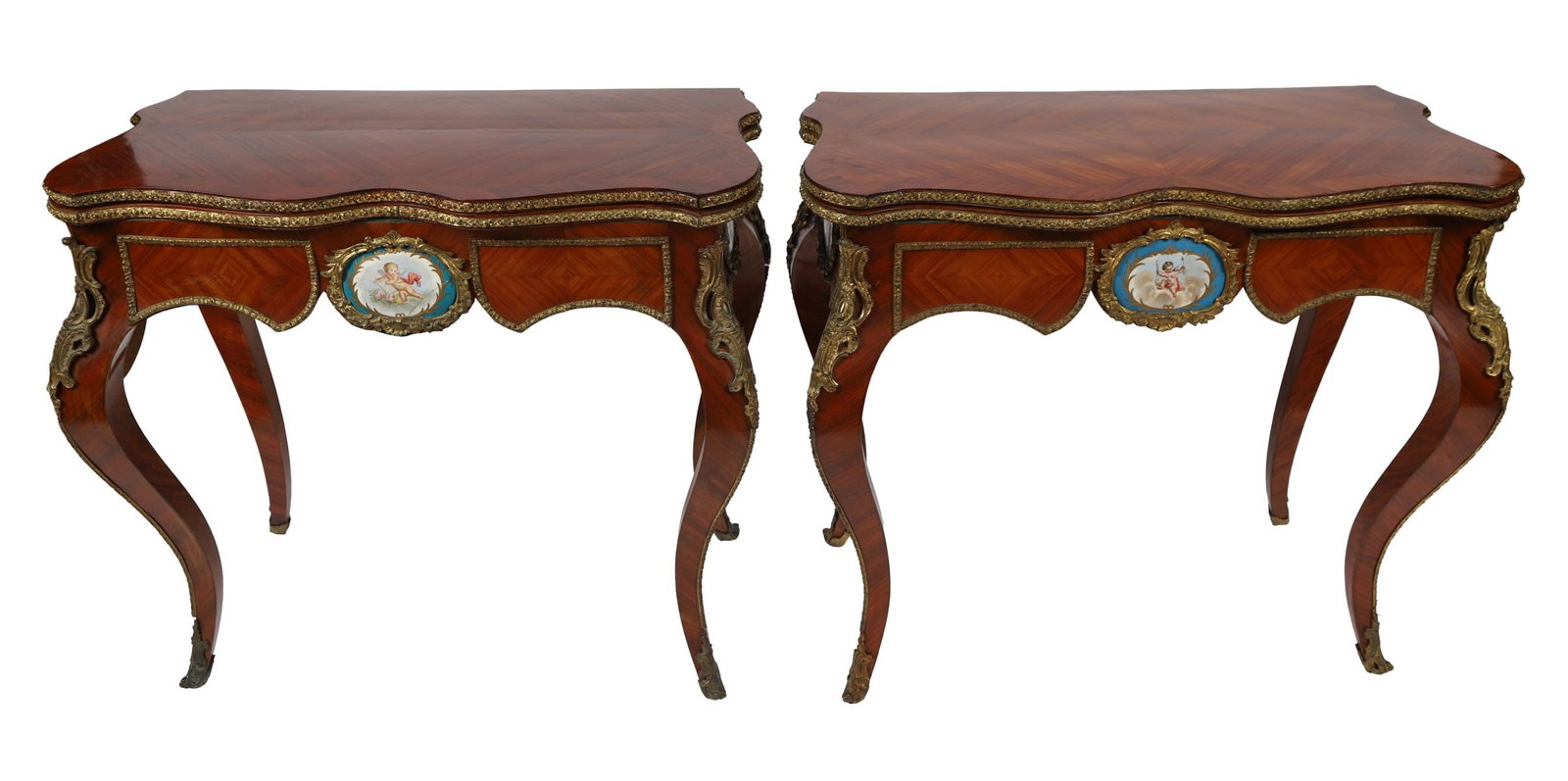 PR KINGWOOD &SEVRES PORCELAIN MOUNTED CARD TABLES: 19TH CENTURY, A fine pair of 19th-century kingwood and ormolu-mounted serpentine card tables, each inlaid with parquetry veneers and centred by a hand-painted Sèvres porcelain plaque depicting classi