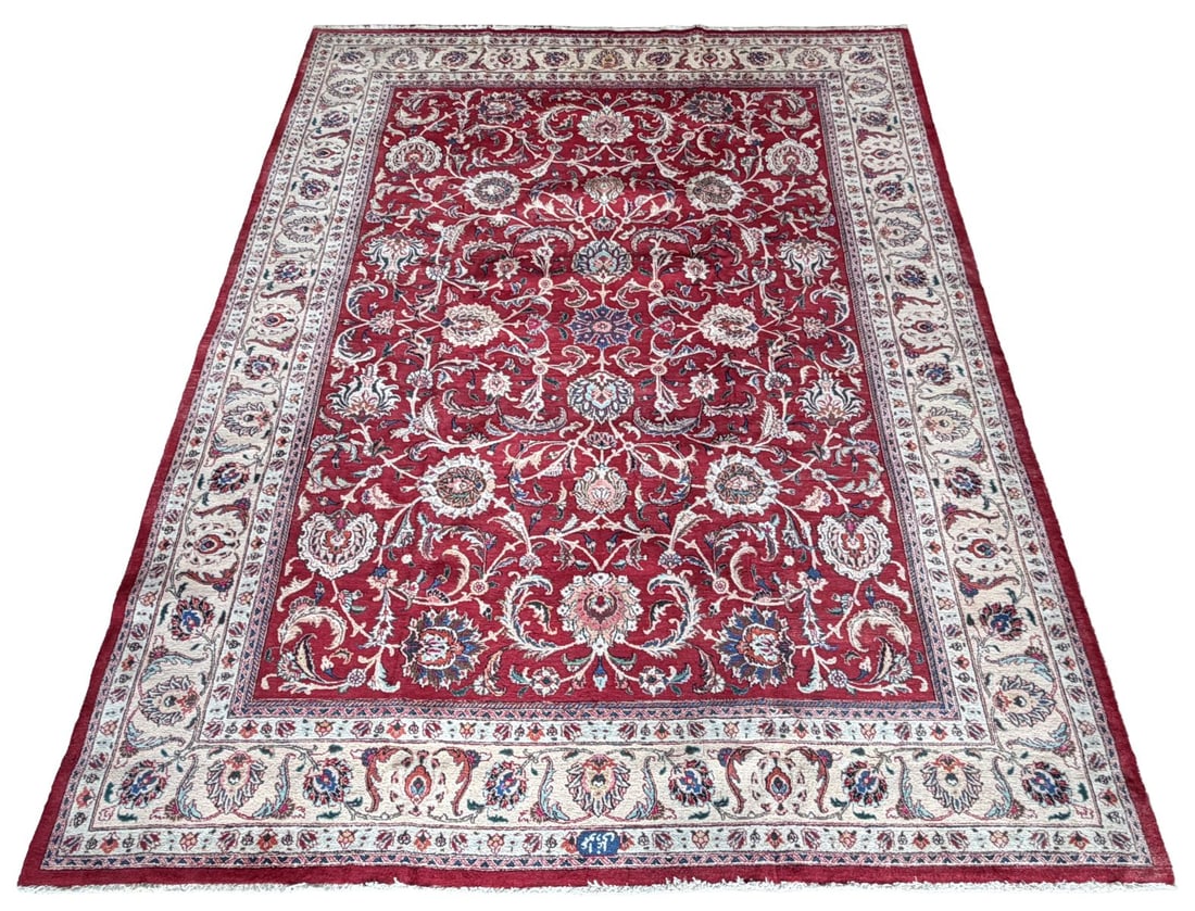 LATE 20TH-CENTURY NORTHEAST PERSIAN MESHED CARPET: DESIGNED BY AMOO OAGHLI, The richly coloured madder red field densely decorated with an elegant all-over scrolling vine and palmette design, incorporating finely drawn floral sprays in ivory, soft