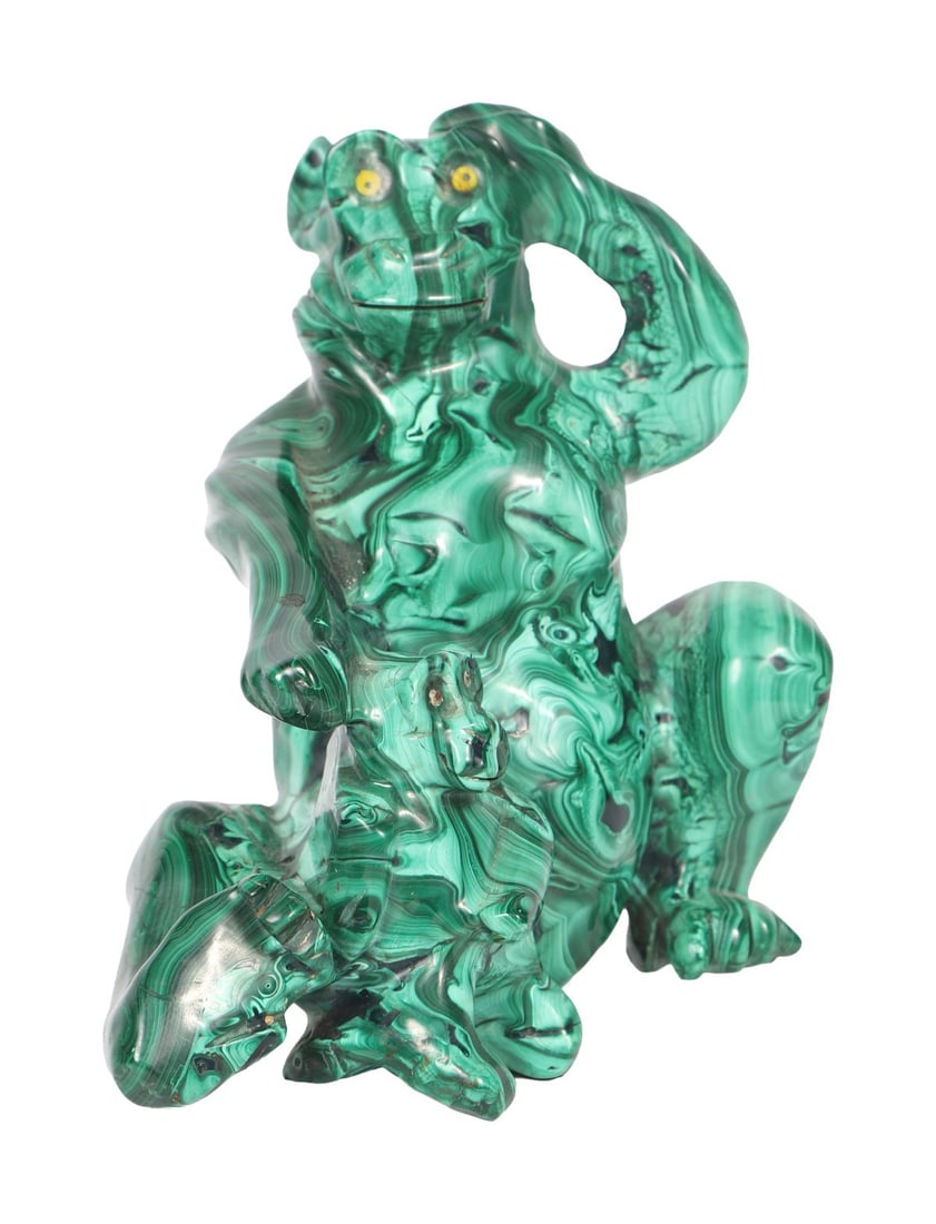 19TH-CENTURY MALACHITE SCULPTURE OF SEATED MONKEY: The carved figure of a monkey in a seated pose, the natural banding of the stone forming decorative surface patterning. SCULPTURE