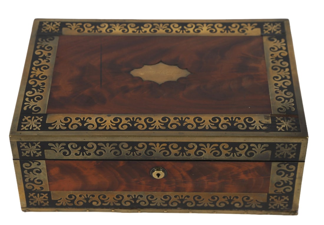 REGENCY MAHOGANY AND BRASS-INLAID LAP DESK: The hinged top centred with a brass cartouche engraved “Harriet A. Caulfield”, opening to a fitted interior. ANTIQUE BOXES