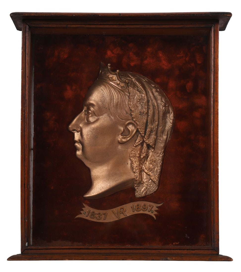 CASED PROFILE BRONZE HEAD OF QUEEN VICTORIA: A bronze profile portrait of Queen Victoria, commemorative type, mounted within a glazed display case, dated 1837–1897. SCULPTURE