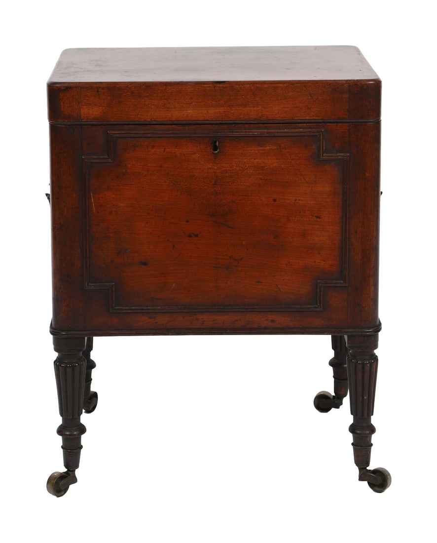 REGENCY MAHOGANY WINE CELLARETTE: BY GILLOWS OF LANCASTER. Of sarcophagus form with hinged lid enclosing fitted interior, raised on turned legs with castors. FURNITURE