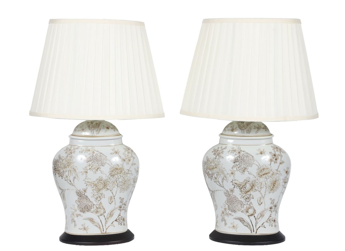 PAIR OF PORCELAIN TABLE LAMPS: Of baluster form, decorated with floral sprays in monochrome tones, mounted on ebonised bases, complete with shades. LIGHTING