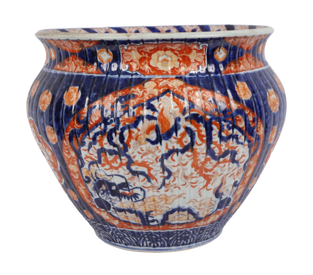 LARGE 19TH CENTURY JAPANESE IMARI JARDINIERE: A very large 19th-century Japanese Imari jardinière of deep rounded form, richly decorated with panels of floral ornament and stylised motifs in iron-red and cobalt blue. JAPANESE