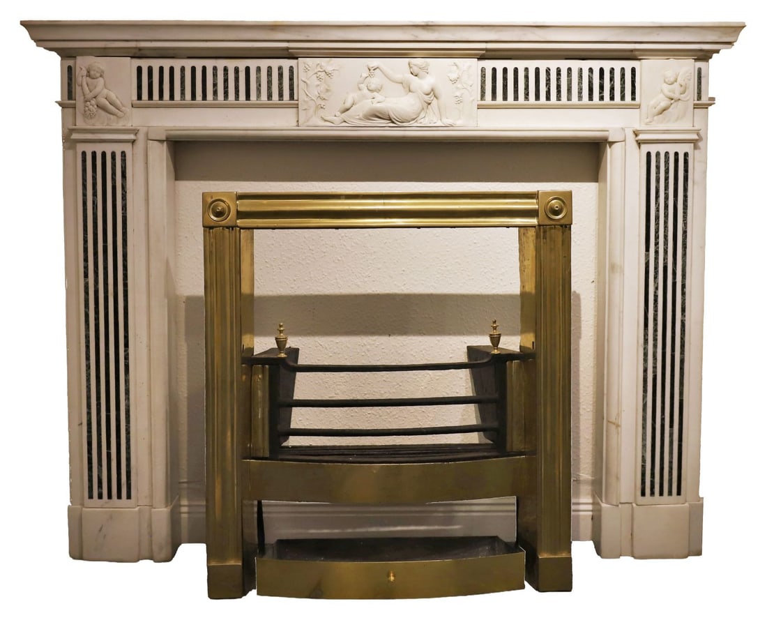 19TH-CENTURY NEO-CLASSICAL MARBLE CHIMNEY PIECE: Statuary white and line inlaid, the moulded mantel above a putti carved panelled frieze, raised on line inlaid pillars. Provenance: Seafield House, Donabate, Co. Dublin. FIRE FURNITURE
