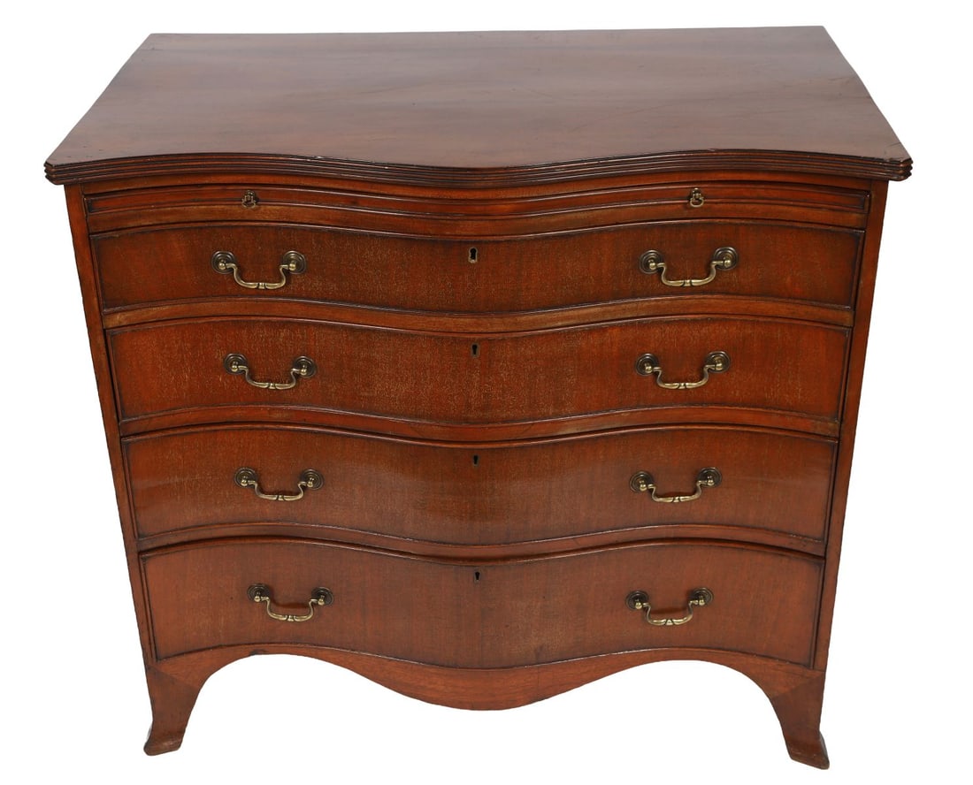 19TH-CENTURY MAHOGANY SERPENTINE CHEST: WITH BRUSHING SLIDE, The serpentine front above a brushing slide and four long graduated drawers, fitted with brass handles, raised on shaped bracket feet. FURNITURE