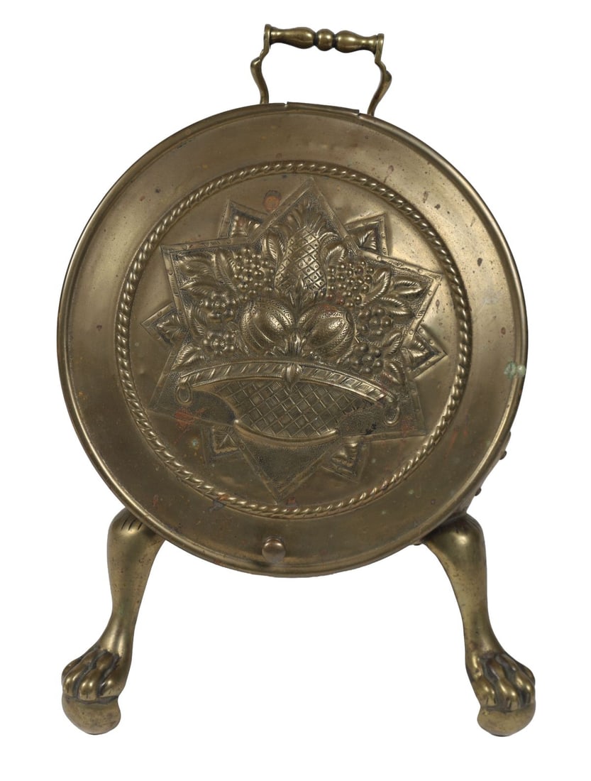 19TH-CENTURY BRASS LOG BARREL: Cylindrical brass log or coal barrel with embossed decoration, fitted with swing handle and raised on paw feet. FIRE FURNITURE