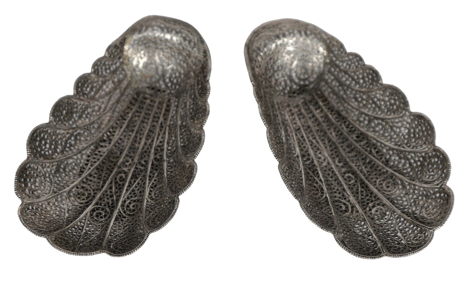 PAIR OF INDIAN SILVER FILIGREE DISHES: Each of shell form, finely worked with dense scrolling filigree panels, raised on shaped bases. SILVER AND SILVER PLATE
