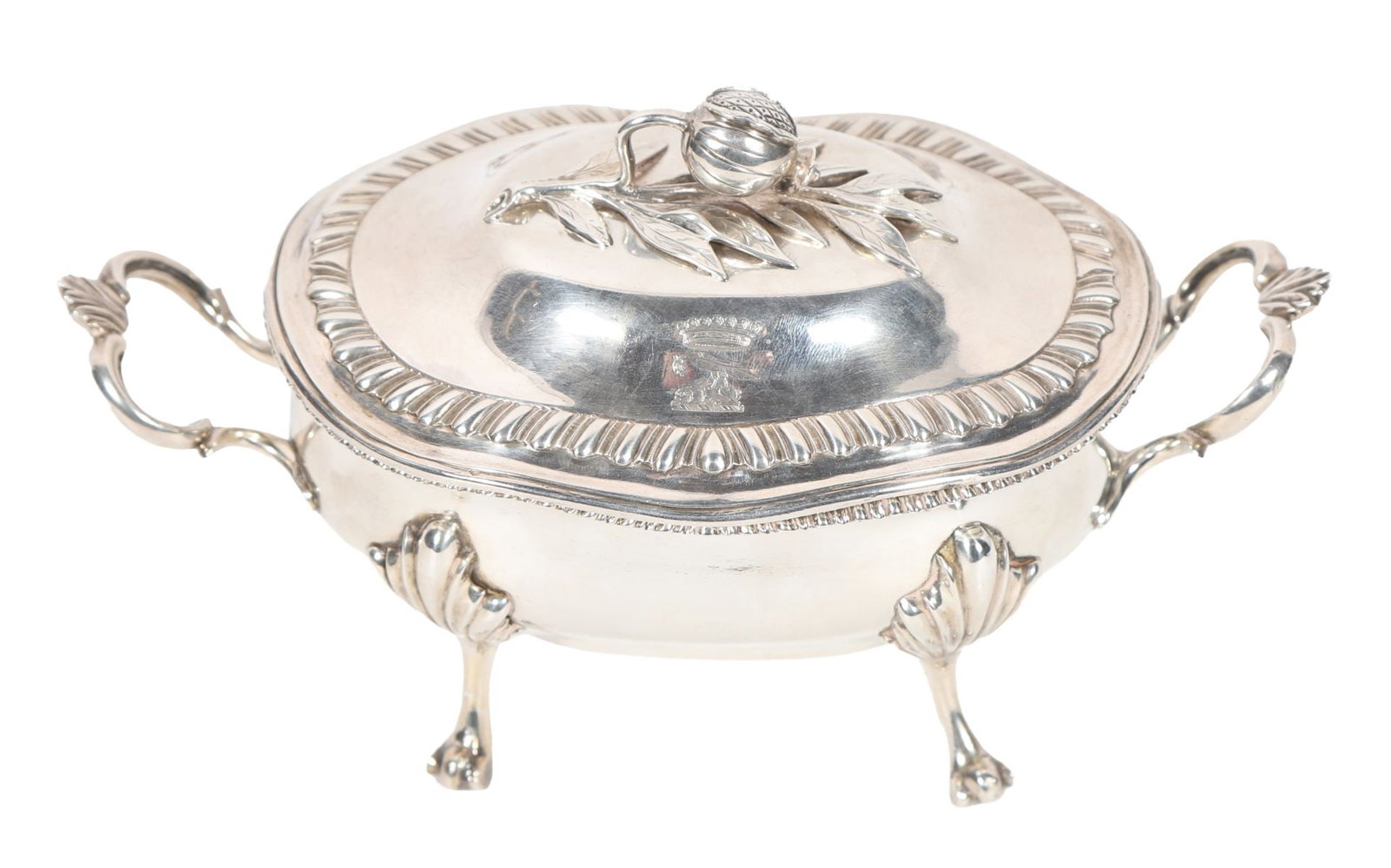 GEORGIAN SILVER TWO-HANDLED BOWL AND COVER: A two-handled bowl with domed cover and finial, raised on four feet with decorative mounts and engraved crest to the lid. 710 grams. SILVER AND SILVER PLATE