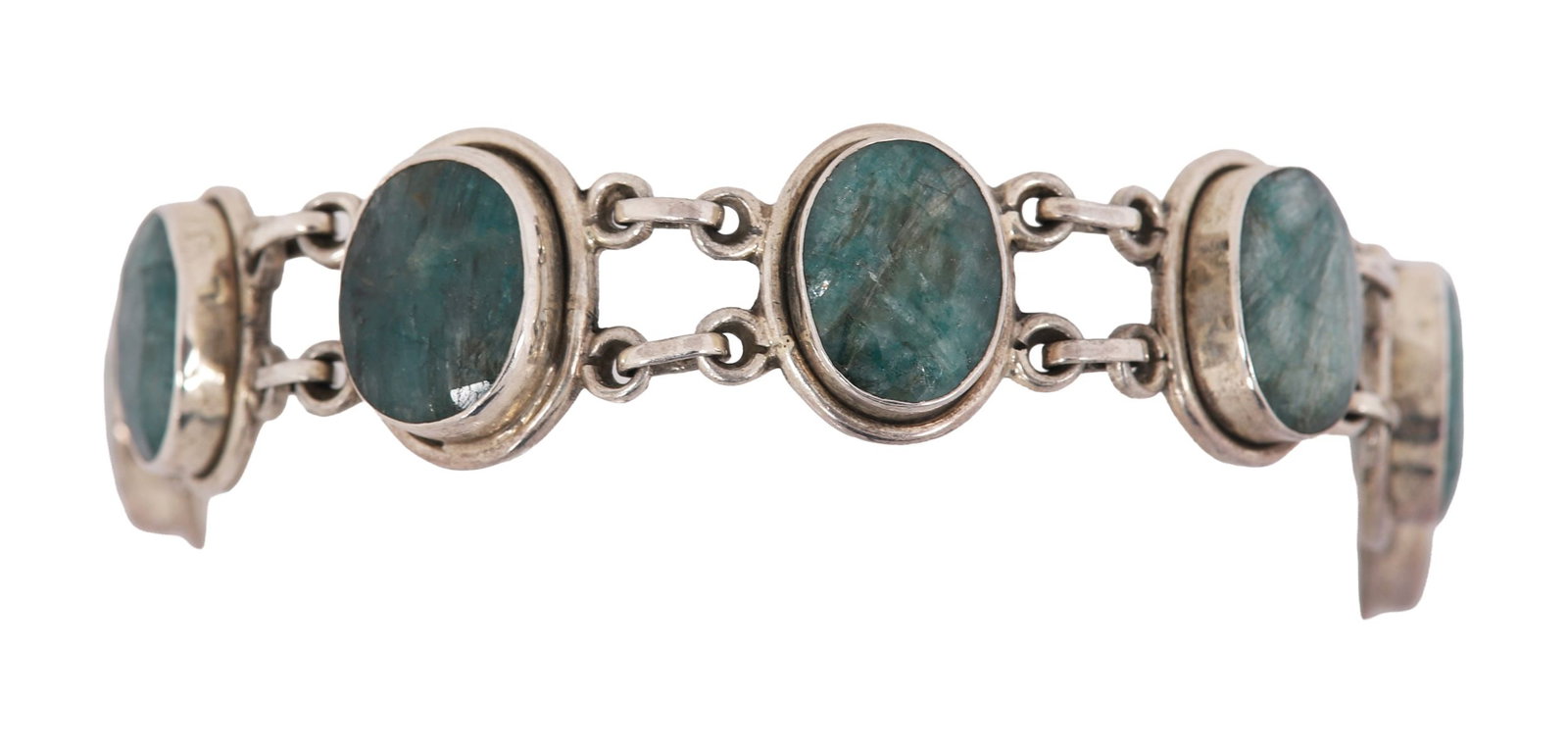 EMERALD AND SILVER BRACELET: A bracelet set with emeralds in silver mounts. JEWELLERY