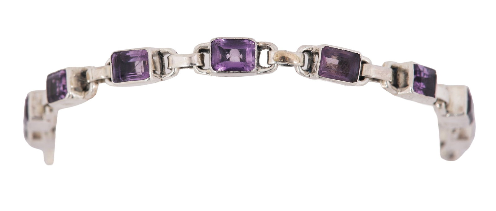 AMETHYST AND SILVER BRACELET: A bracelet set with amethysts in silver mounts. JEWELLERY