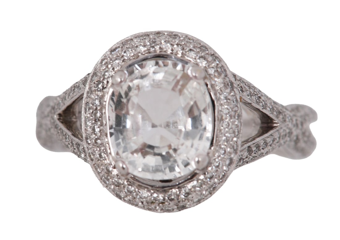 18K WHITE GOLD SAPPHIRE AND DIAMOND RING: An 18-carat white gold ring set with a sapphire (approx. 6.95 carats) and diamonds, marked 750. JEWELLERY