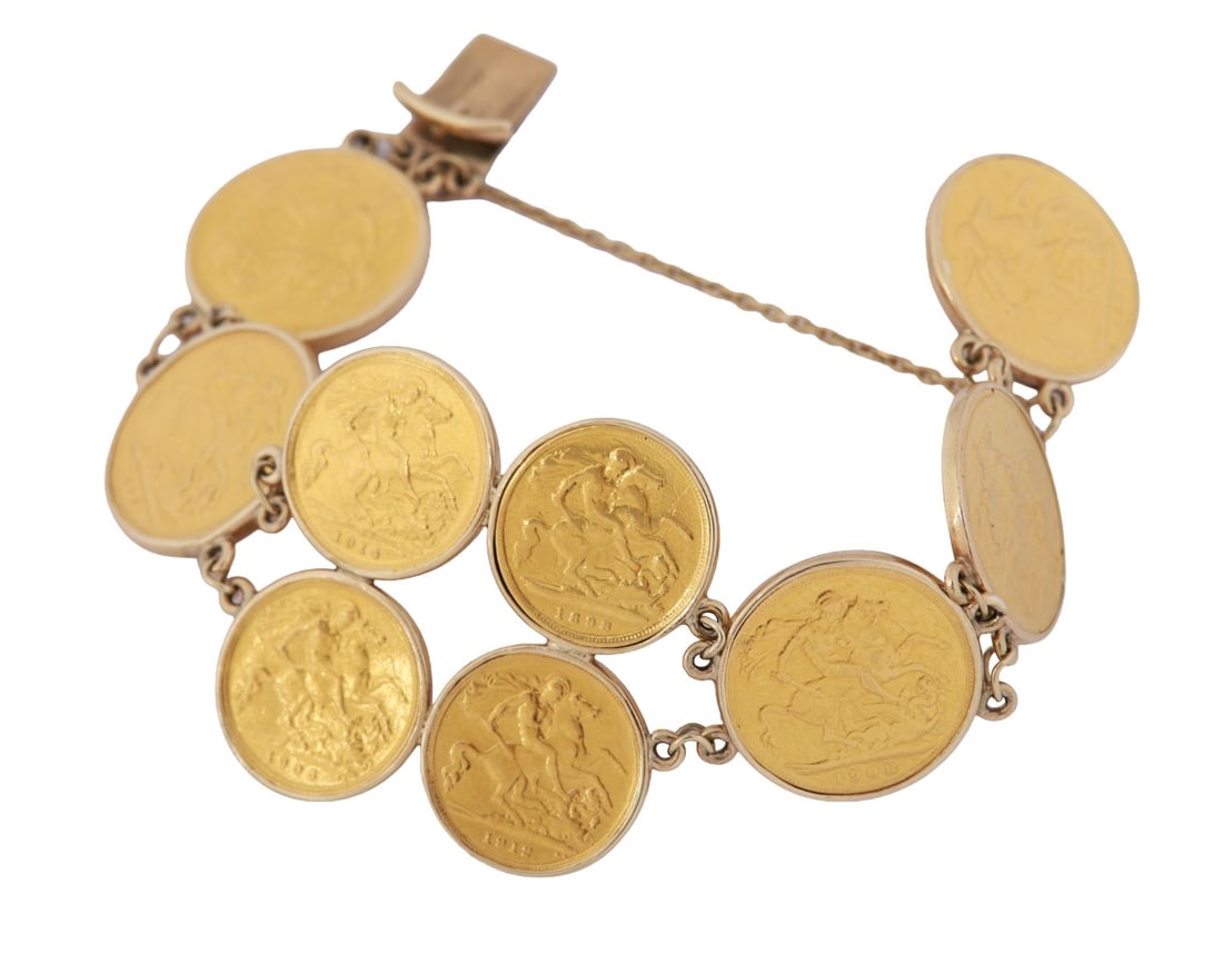 GOLD SOVEREIGN COIN BRACELET: Bracelet composed of five full gold sovereigns and four half sovereigns, each mounted within a linked setting. JEWELLERY