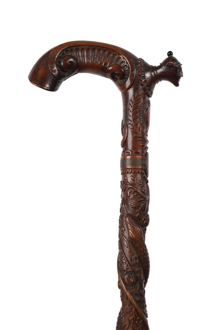 1ST WORLD WAR CARVED WOOD SOUVENIR WALKING STICK: INSCRIBED “SALONIQUE D’ORIENT 1917” A carved hardwood walking stick, the shaft profusely decorated in relief with a spiralling serpent and foliate ornament, the handle carved with a stylised