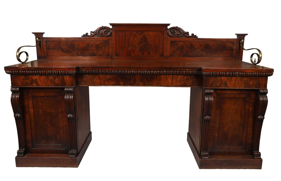MAHOGANY PEDESTAL SIDEBOARD: BY WILLIAMS AND GIBTON, DUBLIN the rectangular-shaped top below a serpentine arched panelled back above a series of drawers and two panelled doors, stamped Williams and Gibton. FURNITURE