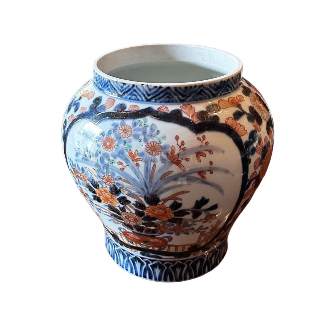 A 19TH CENTURY JAPANESE IMARI URN: A 19th-century Japanese Imari urn, of baluster form, decorated with stylised floral panels and scrolling ornament in iron-red and blue. JAPANESE