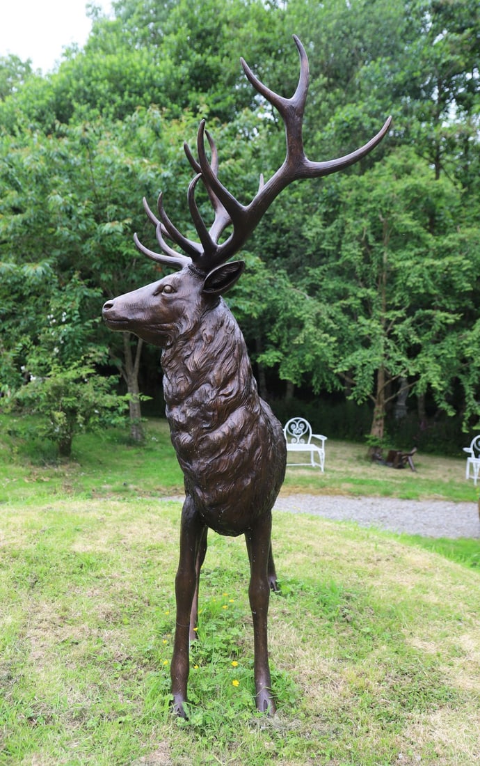 LARGE BRONZE-PATINATED STAG GARDEN SCULPTURE: Impressive bronze-patinated model of a standing stag with finely modelled coat and substantial antlers.
