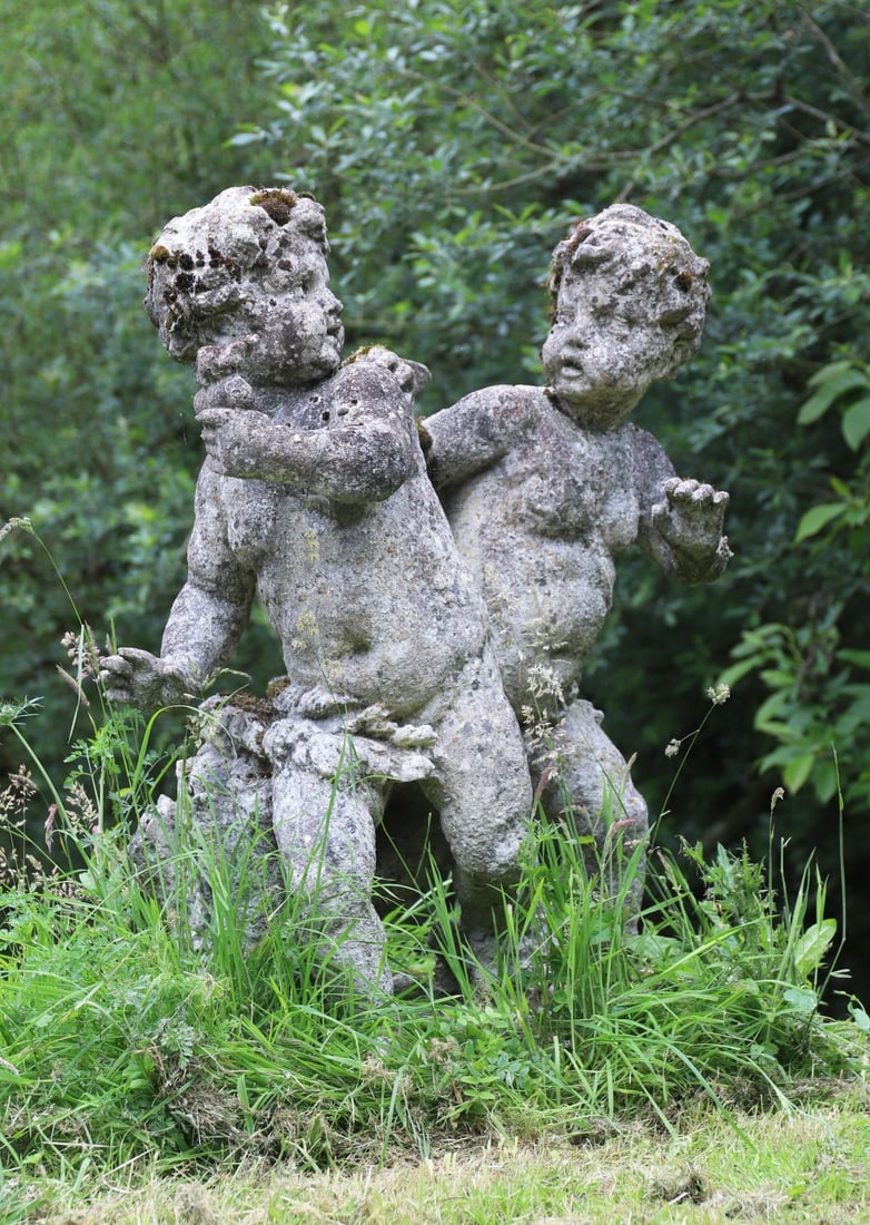 LARGE ITALIANATE STONE SCULPTURE: of playful putti.
