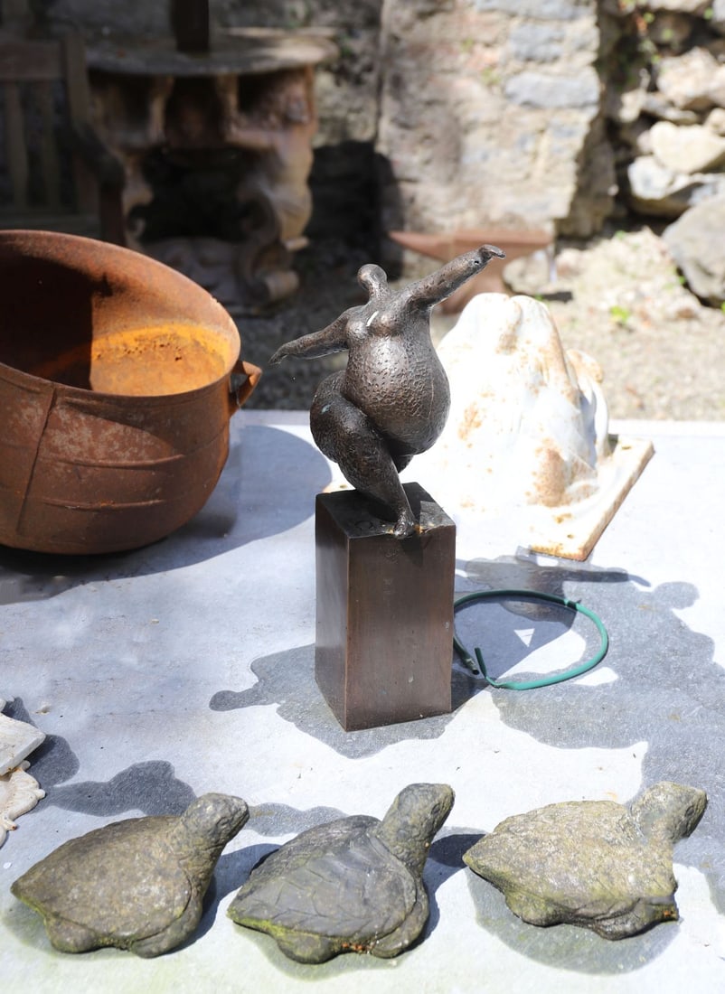 CONTEMPORARY BRONZE SCULPTURE: OF A SEATED FEMALE FORM Modern bronze sculpture depicting an abstract dancing female figure with textured surface, raised on a rectangular plinth.