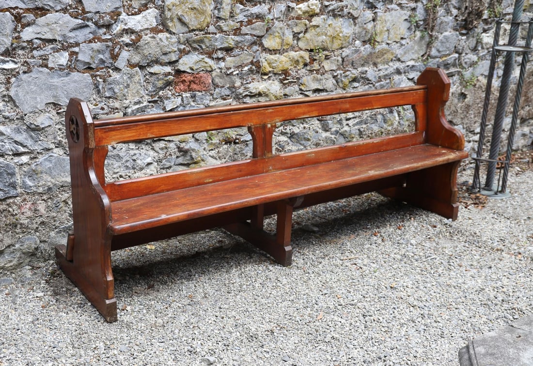 PAIR OF PITCH PINE CHURCH PEWS: Pair of pitch pine church pews, each with shaped end supports centred by a carved Gothic quatrefoil roundel, retaining rich colour and patina.