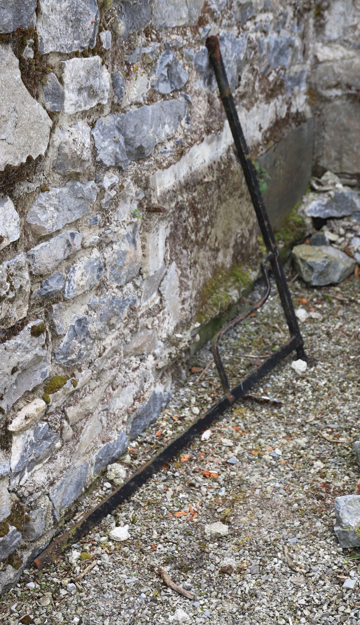 PAIR OF WROUGHT IRON HEARTH CRANES: wrought iron hearth cranes or swinging pot cranes, each with adjustable arms for suspending cooking vessels over an open fire.