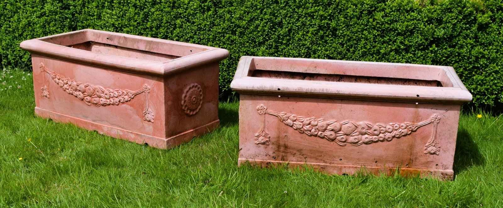 PAIR OF FAUX TERRACOTTA JARDINI?RES: Pair of faux terracotta rectangular jardini?res decorated with fruiting swags and rosette roundels.