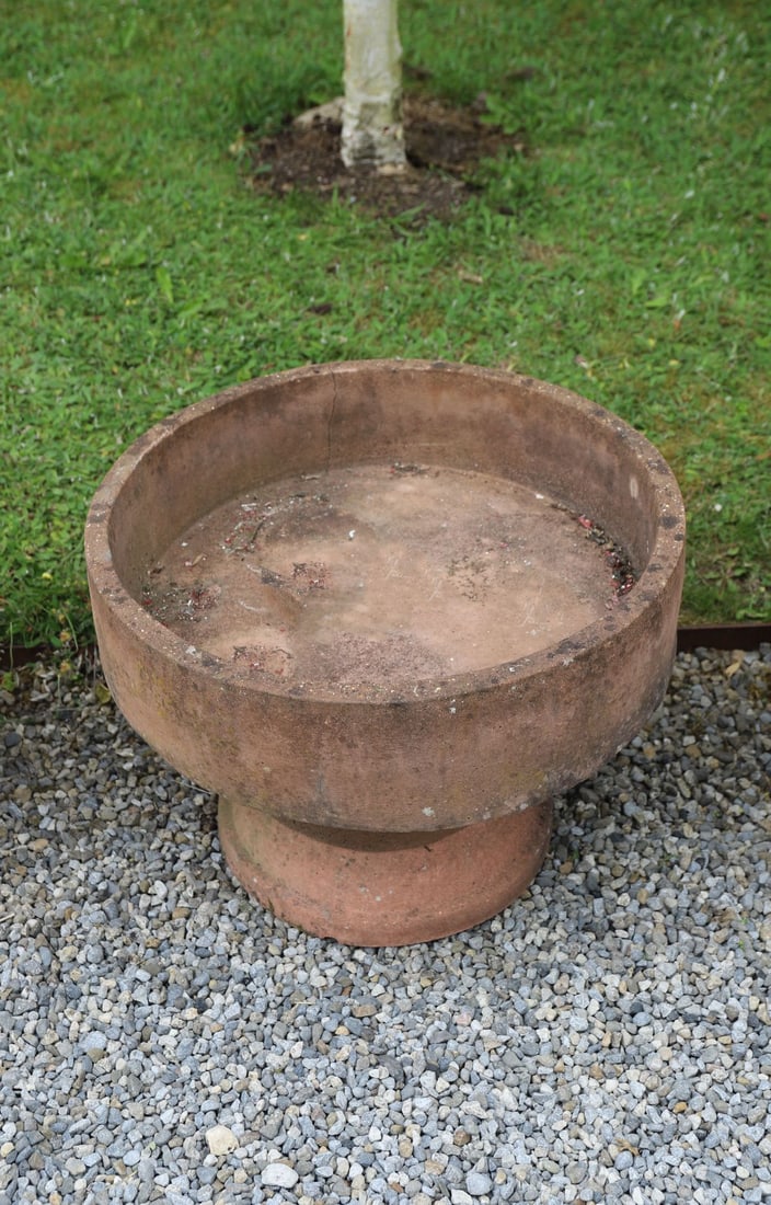 LARGE CIRCULAR TERRACOTTA PLANTER: The deep circular body with broad rim and weathered surface patination.