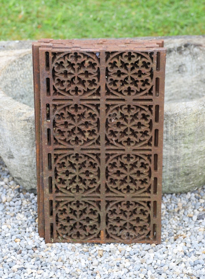 SIX CAST IRON OPENWORK PANELS: The rectangular panels with pierced foliate and geometric decoration, retaining a naturally weathered rusted finish.