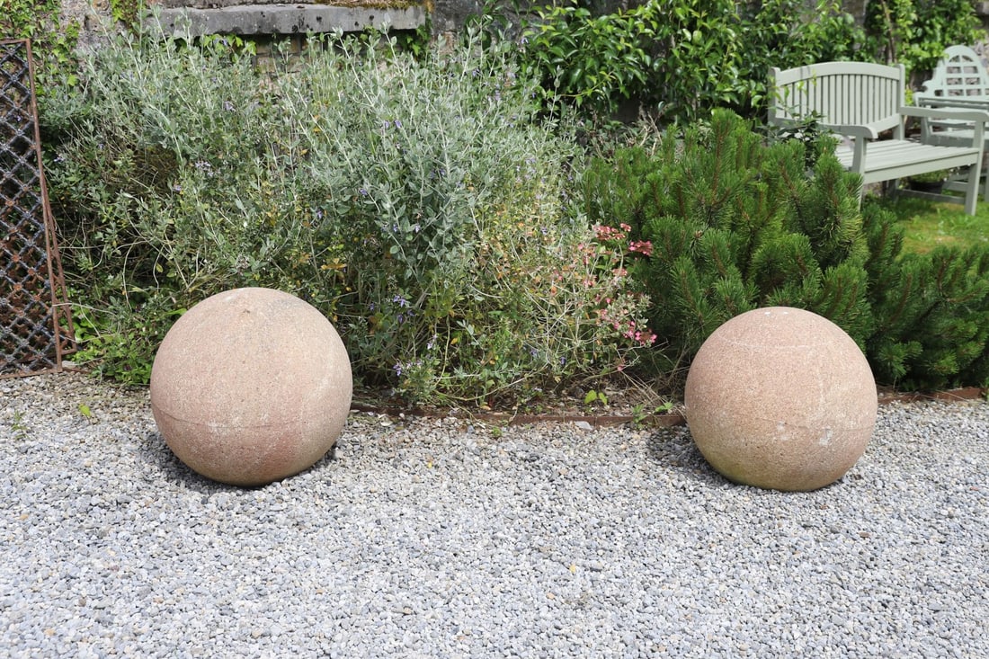 PAIR LARGE COMPOSITE STONE GARDEN SPHERES: A substantial weathered composite stone spheres, suitable as a gate pier ornament or landscape feature.