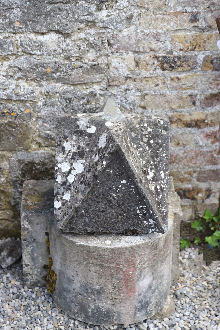 PAIR 19TH-CENTURY LIMESTONE PIER CAPS: Each a substantial 19th-century limestone pier cap of pyramidal form, carved from a single block and retaining weathered surface patination with lichen growth. Formerly mounted as gate or entrance pie