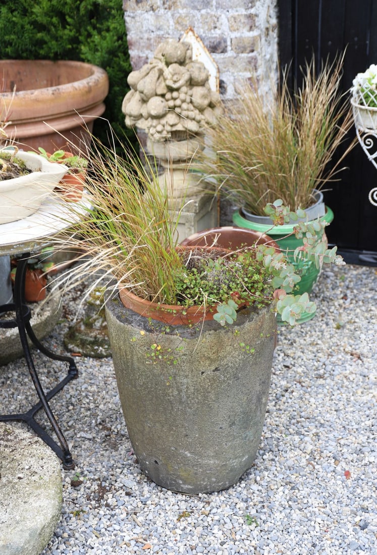 19TH-CENTURY CARVED STONE PLANTER: Large carved stone tapering planter with weathered surface and natural patination.