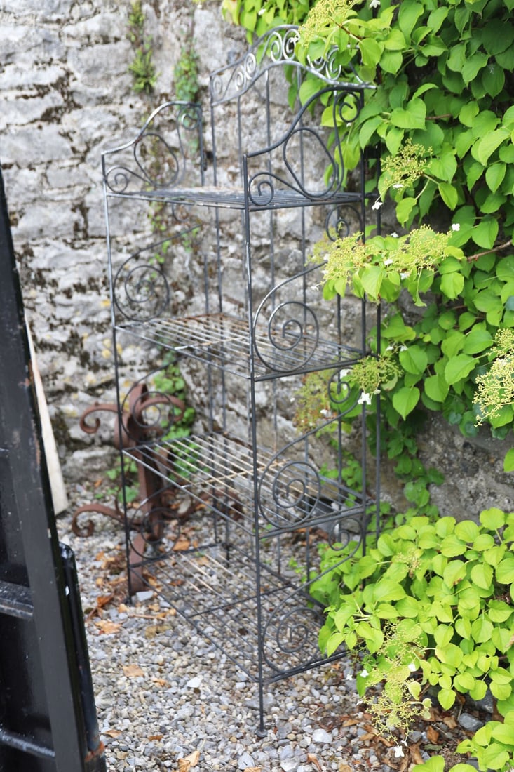 FOLDING METAL GARDEN ETAGERE: Decorative folding metal garden etagere with four graduated shelves and scrollwork decoration.