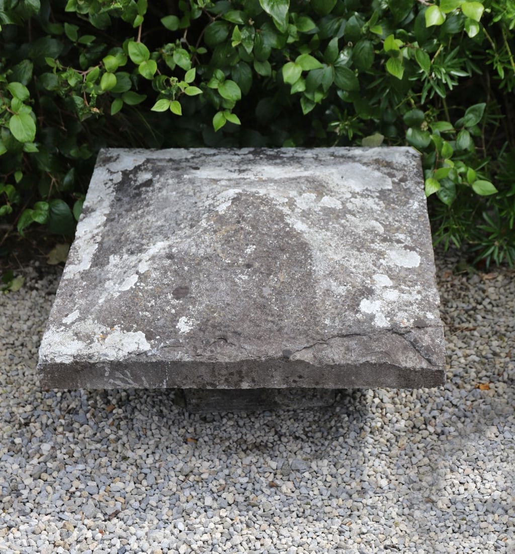 19TH-CENTURY CUT STONE PIER CAP: Substantial cut stone pier cap of pyramidal form with weathered surface and lichen growth.