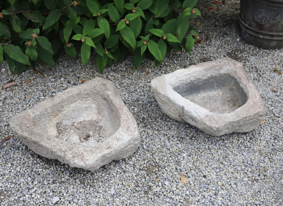 PAIR OF MOULDED STONE TROUGHS: each of rectangular form curved to the fore.