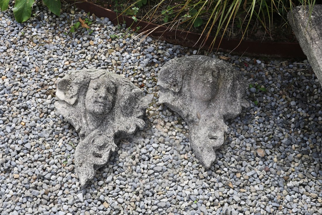 MOULDED GRANITE STONE GARDEN WALL POCKET: Decorative moulded granite wall pocket centred by a mask amongst scrolling foliate ornament.