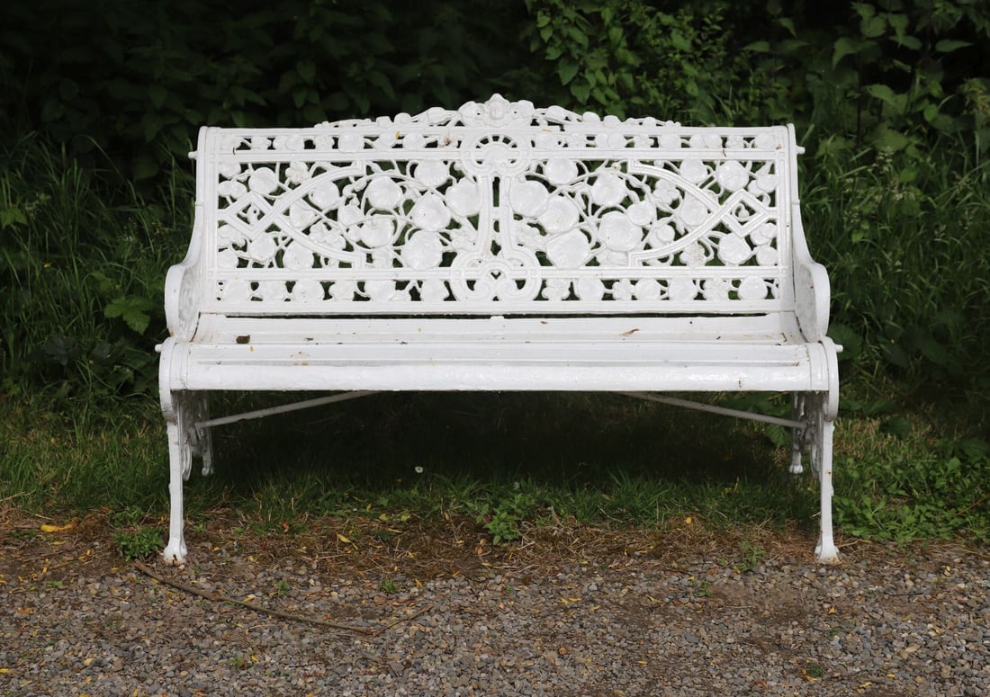 HEAVY CAST IRON GARDEN BENCH - NASTURTIUM DESIGN: A white-painted cast iron garden bench featuring pierced decoration of nasturtium leaves and flowers to the backrest. Slatted seat and ornate side panels with scroll feet.