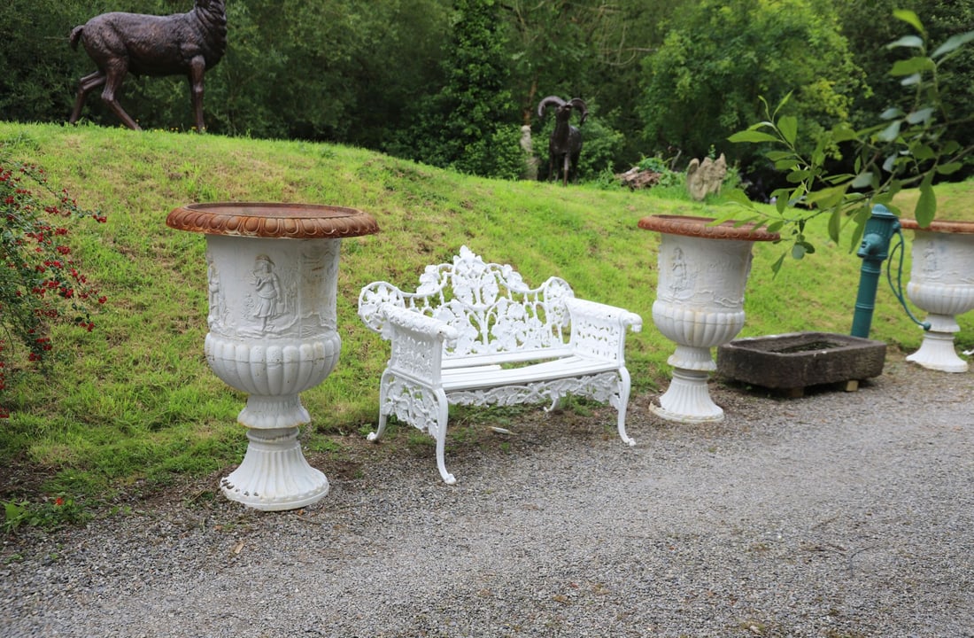 PAIR OF ESTATE CAST IRON MEDICI JARDINI?RES: Pair of substantial cast iron Medici jardini?res, the campana-shaped bodies cast in relief with continuous classical narrative scenes depicting figures within wooded landscapes, beneath gadrooned rims