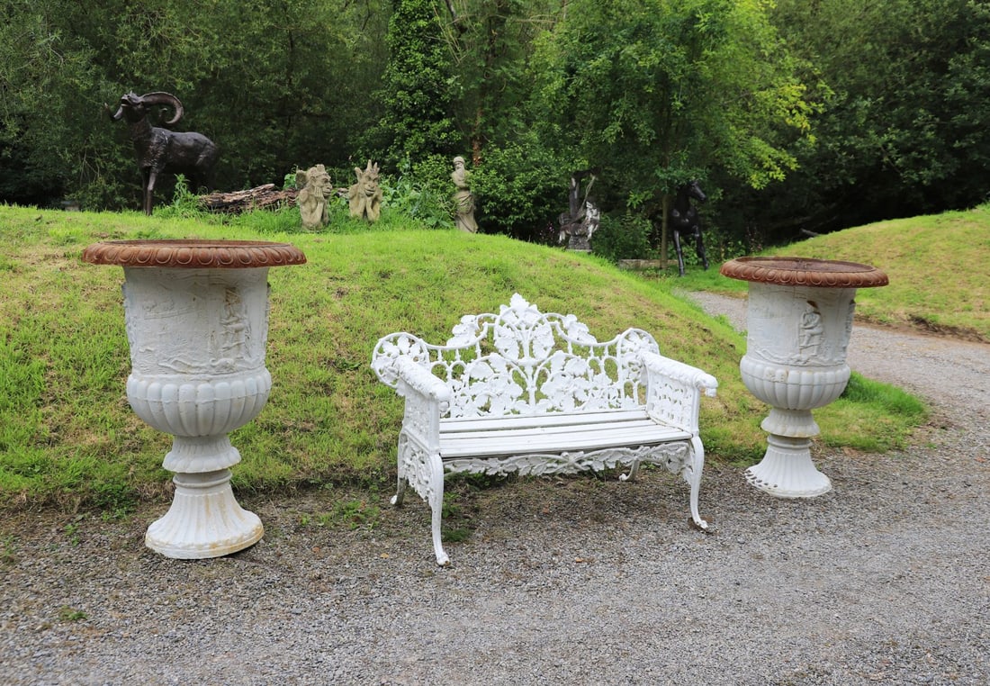 PAIR OF ESTATE CAST IRON MEDICI JARDINI?RES: Pair of substantial cast iron Medici jardini?res, the campana-shaped bodies cast in relief with continuous classical narrative scenes depicting figures within wooded landscapes, beneath gadrooned rims